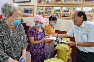 溫陵會館理事長洪世真發扶助金給貧困 無依長者。