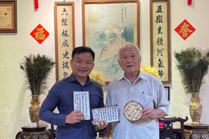 鄔有發書法家（右）向華人文化收藏家麒麟贈送作品。