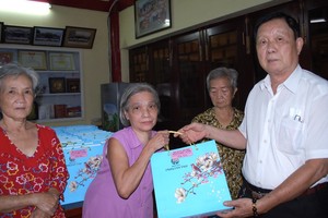 二府會館副理事長謝忠成(右一)向鄉親贈送月餅。