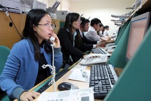 Stock brokers work on the Hanoi Stock Trading Centre (Photo: VNA)