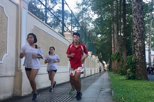 People exercise on pavement near the Independence Palace in HCM City’s District 1. (Photo: VNA)