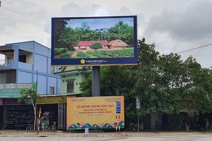 A big screen outdoor LED TV provides information of he birthplace of the late president Ho Chi Minh.