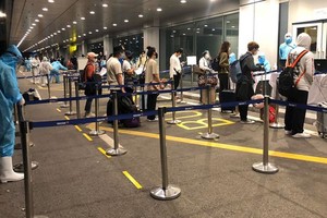 Passengers get health check at Van Don International Airport.