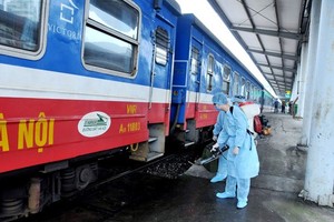 Health workers are cleaning and disinfecting a train.