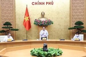 Prime Minister Pham Minh Chinh at a working session with leaders of ministries, vaccine producers and scientists in Hanoi on July 23 (Photo: VNA)