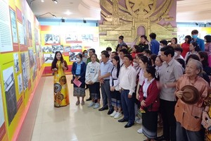 Visitors attend the opening ceremony of the exhibition.