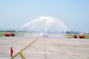 Myanmar Airways International (MAI)'s first flight is welcomed with a water canon salute as it lands at Noi Bai Airport.