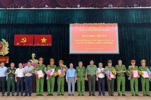 Major General Le Hong Nam, Director of the HCMC Public Security Department on November 8 hands over a decision on applauding the police units that gained outstanding achievements in dismantling a drug trafficking network.