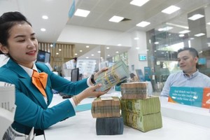 According to the central bank, reducing the interest rates is a flexible solution in line with current market conditions to realize the National Assembly and Government's goal on economic recovery. (Photo: VNA)