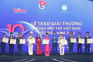Secretary of the Party Central Committee and Chairwoman of its Commission for Mass Mobilisation, Bui Thi Minh Hoai (5th, L) offers certificates of merit to winners of the Vietnam Outstanding Young Faces Awards 2022. (Photo: SGGP)