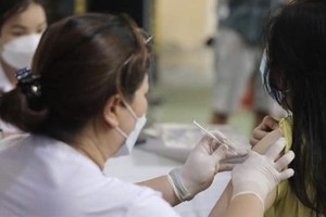 A woman gets vaccinated against Covid-19. (Photo: VNA)
