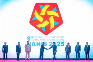 Chairman of the National Assembly Vuong Dinh Hue (4th from right) and other delegates stand in front of the logo of the conference. (Photo: SGGP)