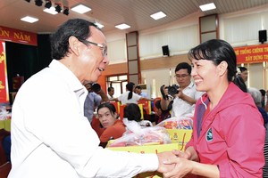 Secretary of the HCMC Party Committee Nguyen Van Nen offers Tet gifts to workers in Dong Nai Province. (Photo: SGGP)