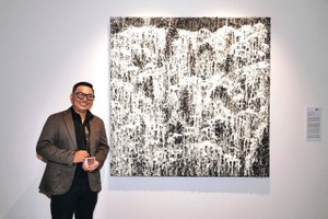 Artist Nguyen Viet Cuong and his artwork titled “Dong chay” (Flow)
