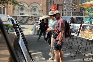 Visitors visit the photo exhibition. (Photo: SGGP)