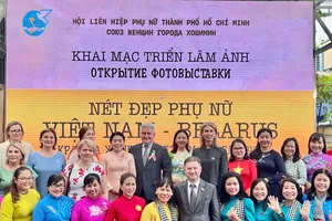 Delegates attend the opening ceremony of the photo exhibition. (Photo: SGGP)