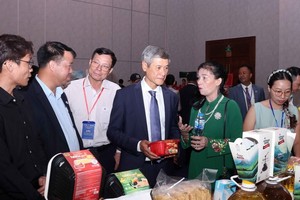 Vietnamese Ambassador to Cambodia Nguyen Minh Vu and Cambodian businesspeople visit the Vietnamese booth. (Photo: VNA)