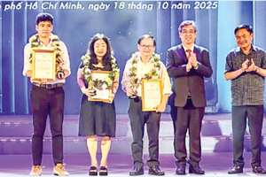 Vice Secretary of the Ho Chi Minh City Party Committee and Chairman of the Vietnam Fatherland Front Committee of the city Nguyen Phuoc Loc (3nd, R), and Mr.Bui Anh Tan, Vice President of the Ho Chi Minh City Union of Literature and Arts Associations (R), present certificates of merit and commemorative medals to authors in the field of literature. (Photo: SGGP)