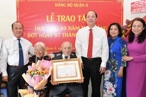 Phó Bí thư Thành ủy TPHCM Nguyễn Hồ Hải chúc mừng và trao Huy hiệu 80 năm tuổi Đảng cho đồng chí Nguyễn Duy Thi. Ảnh: VIỆT DŨNG