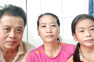 阮氏美泉（中）与丈夫和女儿。