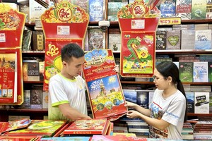 香庄文化公司人员在交货前检查“西贡-胡志明市，50年发展与融入”日历。