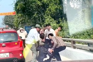 民众试图阻止一名抱着两个孩子的妇女投河自尽。