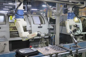 Robot hands in the assembly line of a manufacturing plant of Juki Company