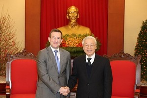 General Secretary of the Communist Party of Vietnam Nguyen Phu Trong (R) and French Ambassador to Vietnam Bertrand Lortholary