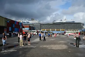Cruise ship, carrying 4,000 tourists, docks at Chan May Port