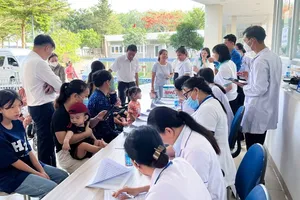 Nhân viên y tế tiếp đón, hướng dẫn và hỗ trợ làm thủ tục khám cho trẻ