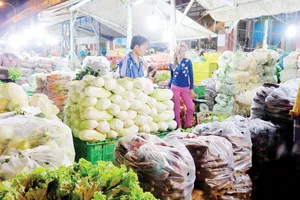 Kinh doanh rau tại chợ đầu mối nông sản Hóc Môn. Ảnh: Quốc Sơn