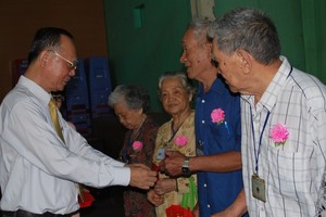 穗城會館理事長盧耀南向高齡鄉親頒發利是。（圖源：趣兒）