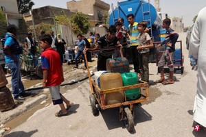 伊拉克重鎮摩蘇爾的平民於7月18日領取聯合國兒童基金會所提供的飲用水。 （圖源：路透社）