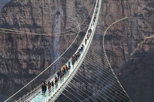 遊客在紅崖谷景區玻璃橋上行走體驗。（圖源：新華網）