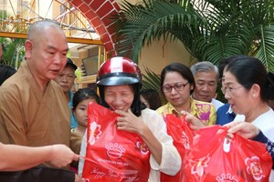 武氏蓉同志和釋慧功上座向窮人贈送禮物。