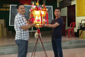 陳昶霖（左）與陳良（右）喜迎“蓮花寶燈”。