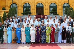 國家副主席鄧氏玉盛同永隆省革命有功者代表團在主席府前合影留念。（圖源：越通社）