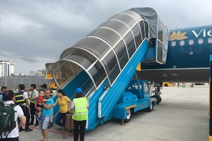 由於發生技術故障，乘坐VN117航班的乘客要下機返回機場候機廳。（圖源：D.Tuấn）