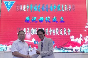 福中校友俱樂部執委會會長梁順（右）向陳佩姬中學報效。