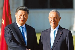 習近平與迎接他的德索薩握手。（圖源：路透社）