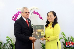 市人民議會主席阮氏麗（右）向古巴國務委員會秘書奧梅羅‧阿科斯塔‧阿爾瓦雷斯贈送紀念品。（圖源：VOH）