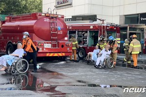 當地時間24日，韓國京畿道金浦市的一家護理醫院發生火災。圖為消防人員正在疏散患者。（圖源：News 1）