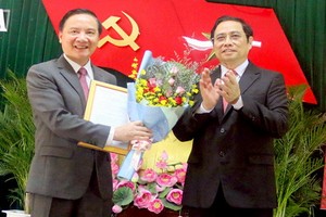 中央組織部長范明政代表黨中央政治局向阮克定同志（左）頒授人事委任《決定》並送鮮花祝賀。（圖源：安平）