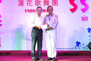 陳志華團長向本報編輯部主任 范興（左）轉交善款。