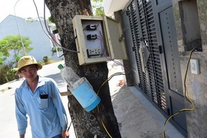 因安置區內未有電力系統，民眾須從露天電箱用電線把電源引接入屋內使用。