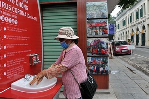 一名女士在李太祖塑像區域附近的洗手站洗手。