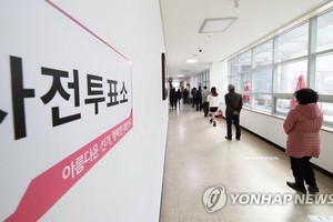 4月10日上午，在京畿道安養市東安區虎溪三洞幸福福利中心，排隊投票的選民保持社交距離。 （圖源：韓聯社）