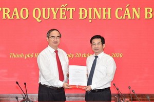 市委書記阮善仁（左）向楊玉海同志頒授黨中央書記處批准出任2015-2020年任期市委常務處委員職務的《決定》。（圖源：越勇）