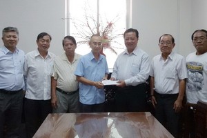 梁萬榮理事長(右三)將賑災善款轉交予范興主任。