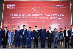 新華集團(越南)董事及新華創新首席執行官蔡卓思(左七)與多國駐胡志明市總領事及商業協會代表合影。